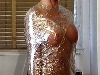 Big tits hottie wrapped in plastic and teased