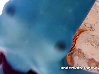 Redhead Mia stripping underwater part 1