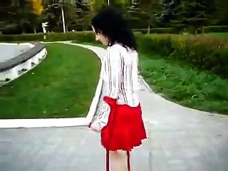 Amputee girl wearing a single red heel