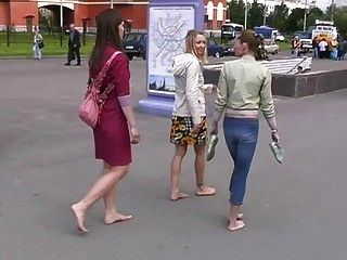  3 girls walking barefoot in the street