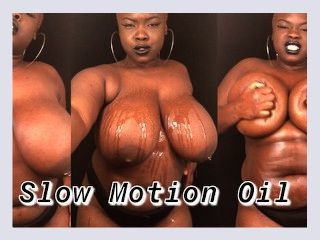 Slow motion BBW rubbing oil on big natural tits and body