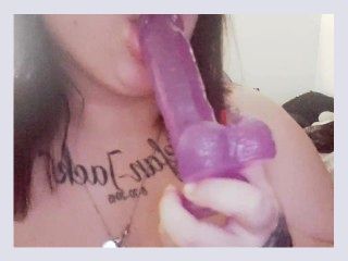 Goth slut sucking on a dildo 