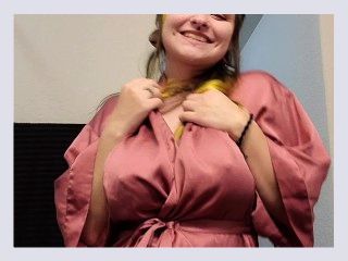 Goth girl gives playful strip tease dance in silk robe 