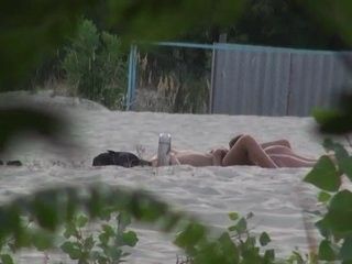 Voyeur spies on pussy licking at a beach