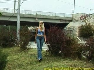 Hot blonde babe peeing in park