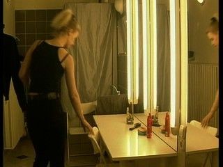 Blonde strips and admires herself in mirror