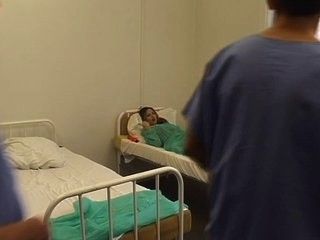 Brunette fucked by two male nurses