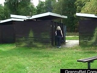 Old blonde is banged by young guy outdoors
