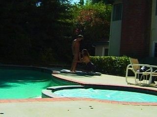 Redhead gives some head by the pool